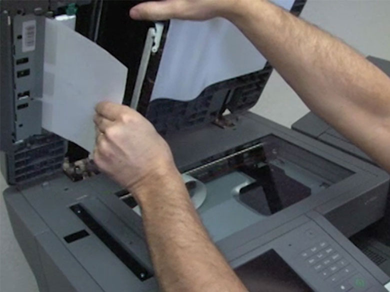 Extraiga el papel atascado del interior del alimentador automático de documentos.